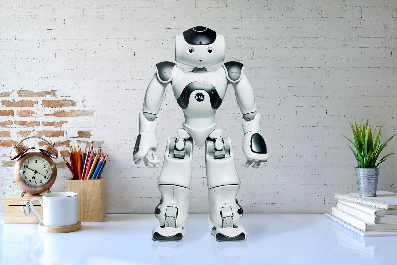 Robot Nao na białym biurku na recepcji.